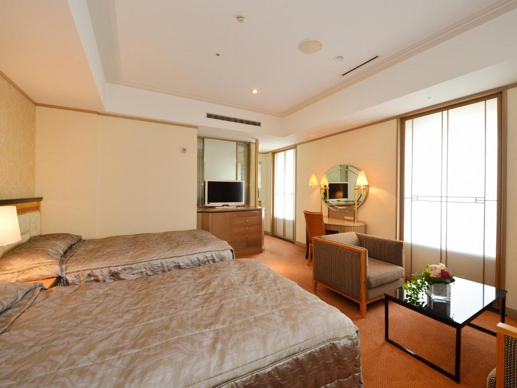 Postel nebo postele na pokoji v ubytování Hotel Crown Palais Kobe