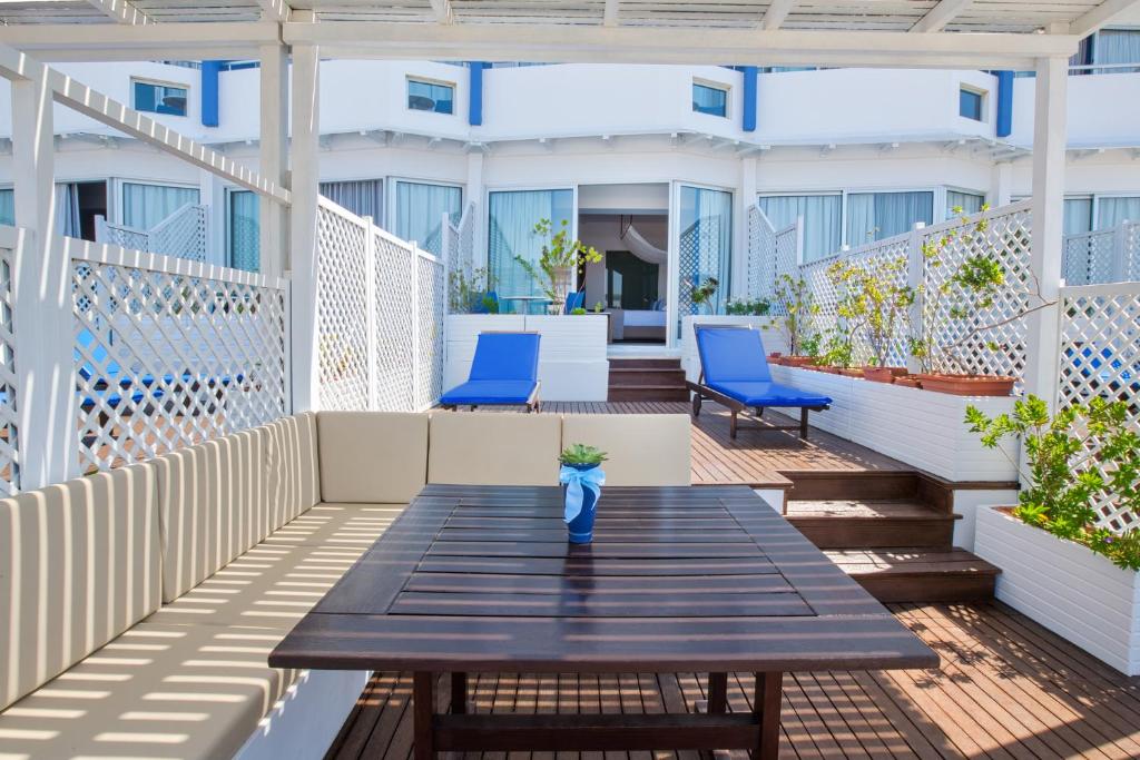 a blue vase sitting on a wooden table on a patio at Lordos Beach Hotel & Spa in Larnaca