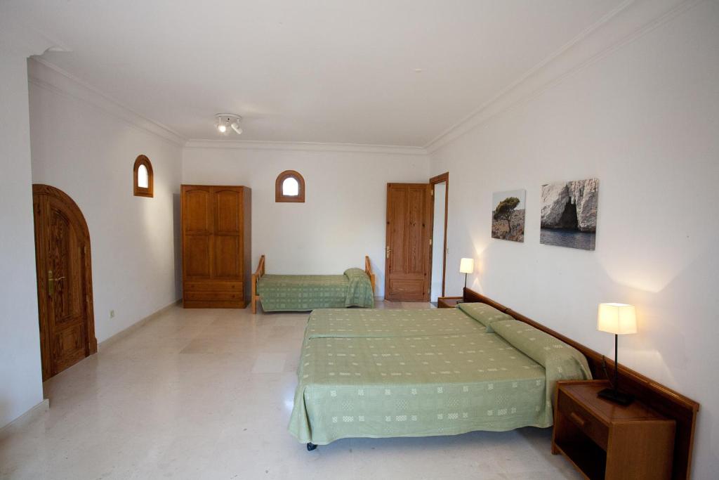 Postel nebo postele na pokoji v ubytování Villa Sa Coma