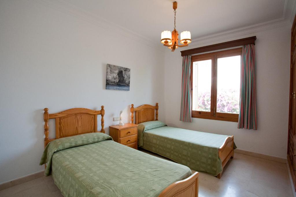 Postel nebo postele na pokoji v ubytování Villa Sa Coma