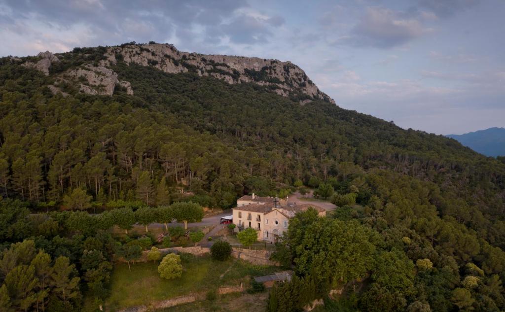 a house in the middle of a mountain at Santuari de la Mare de Déu de la Salut de Terrades in Terrades