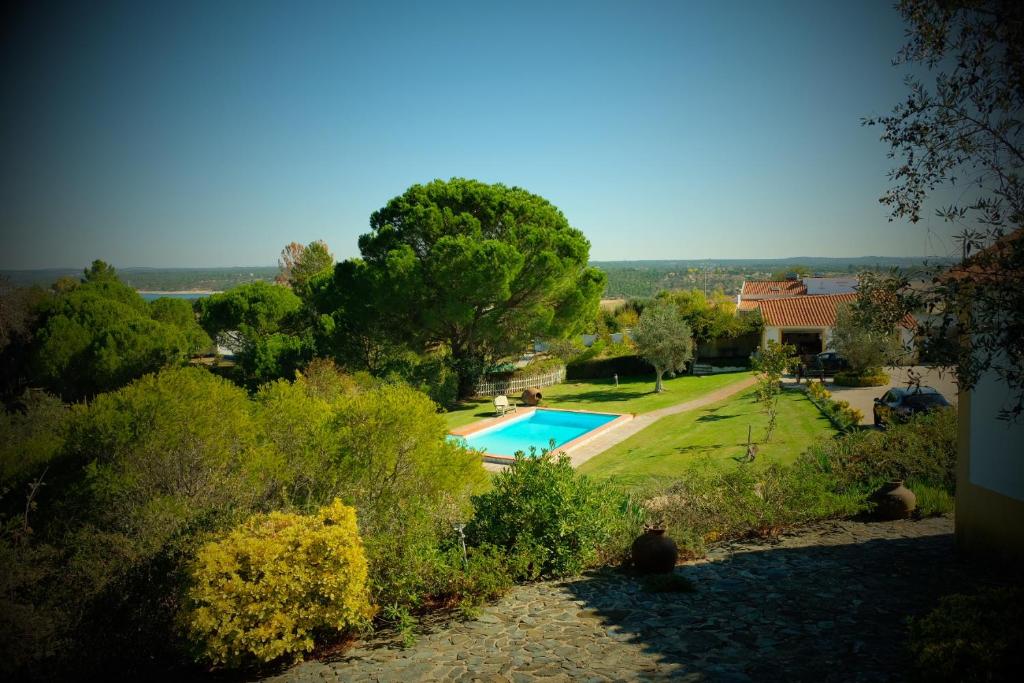 a view of a swimming pool in a yard at Monte Velho Country House in Montargil