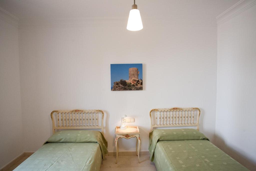 Postel nebo postele na pokoji v ubytování Villa Sa Coma