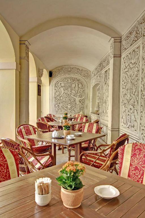 a restaurant with tables and chairs in a room at Alchymist Grand Hotel and Spa - Preferred Hotels & Resorts in Prague