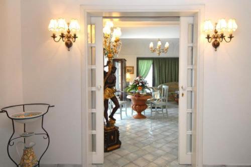 a living room with a woman standing in the doorway at Albergo La Conca Azzurra in Conca dei Marini