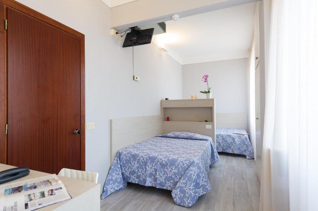 A bed or beds in a room at Albergo Battelli