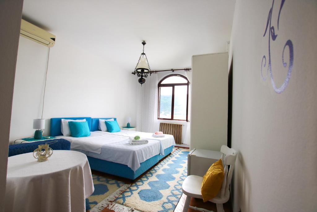 a bedroom with two beds and a table in it at Villa Nena in Herceg-Novi
