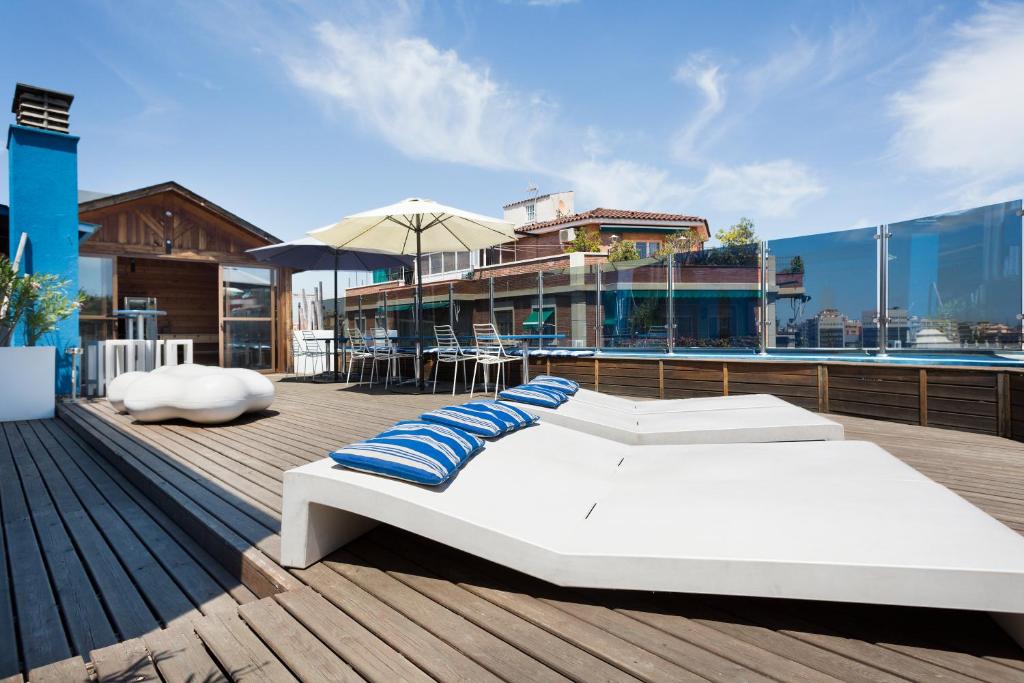 a blue and white boat sitting on top of a dock at Hotel Acta Azul Barcelona in Barcelona