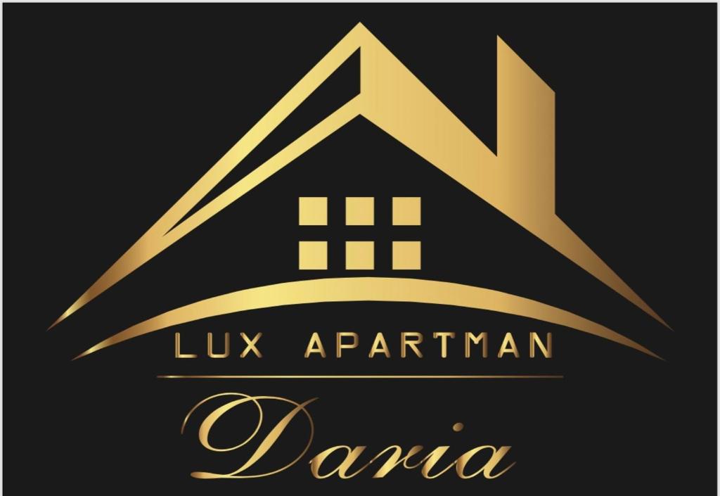 a gold logo with the letter k and a house at Lux Apartman Daria in Zlatibor