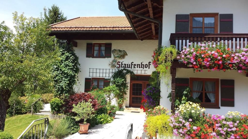 a building with flowers on the side of it at Pension Staufenhof in Inzell