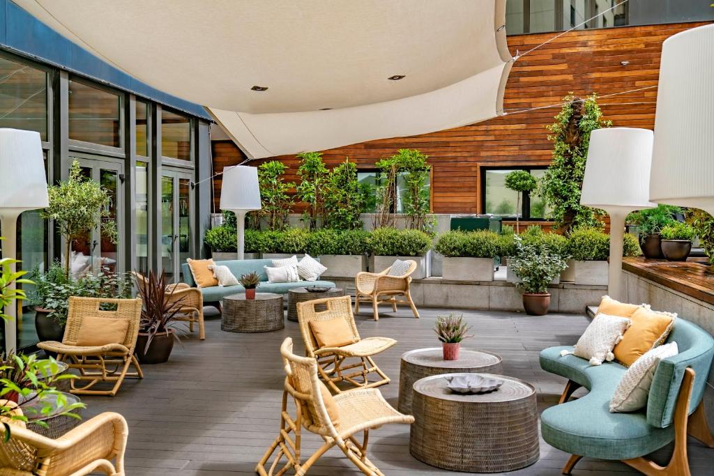 an outdoor patio with chairs and tables at Vincci Soho in Madrid