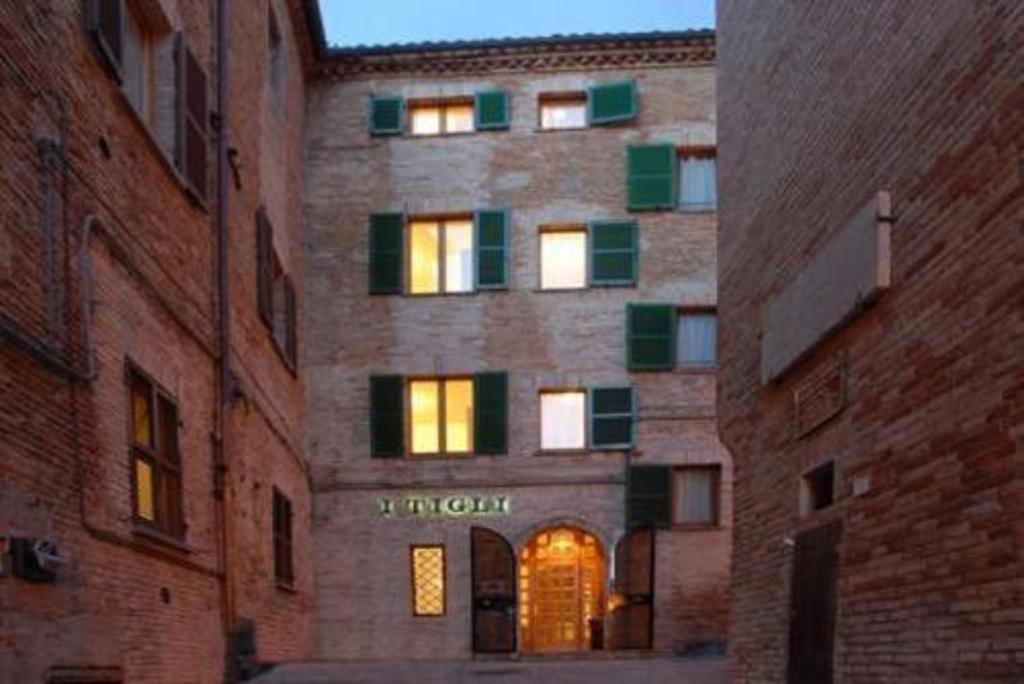 a brick building with an entrance to a building at Hotel I Tigli albergo diffuso in Corinaldo