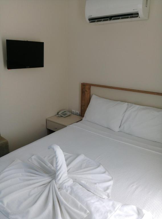 A bed or beds in a room at Rich Melissa Hotel