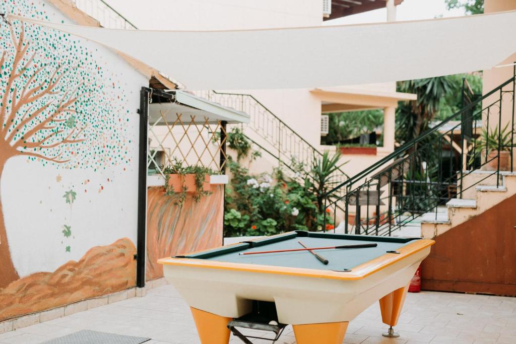 a pool table in the courtyard of a house at Wilde Rose Hotel in Dassia