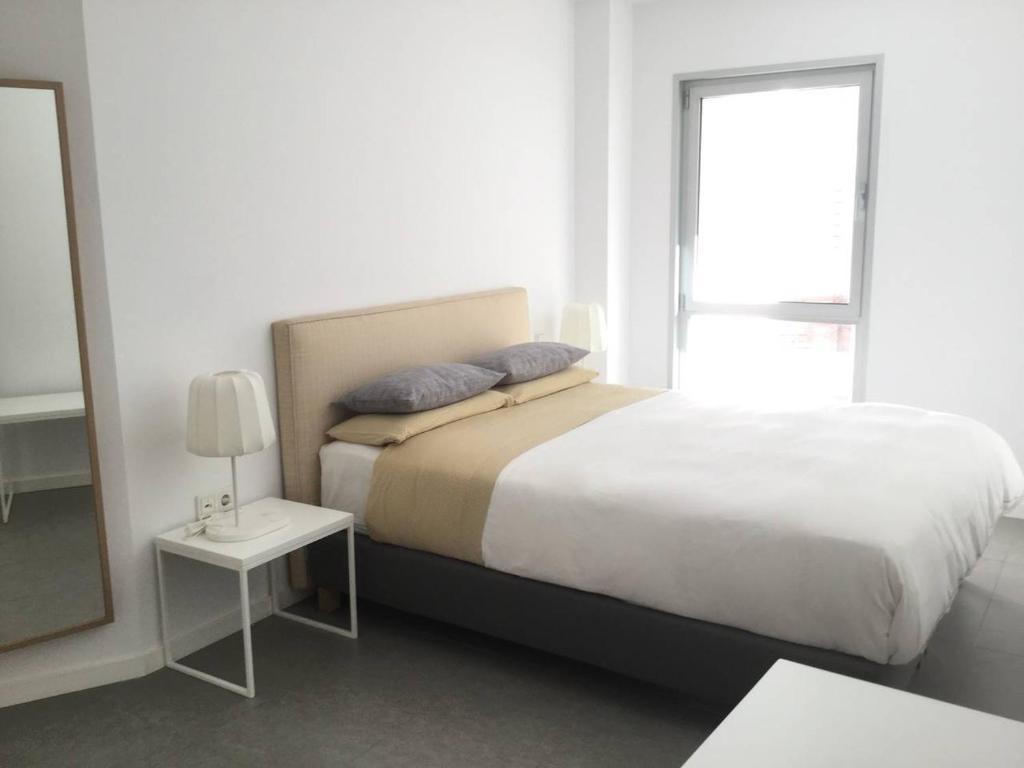 A bed or beds in a room at AMAZING DUPLEX on the beach