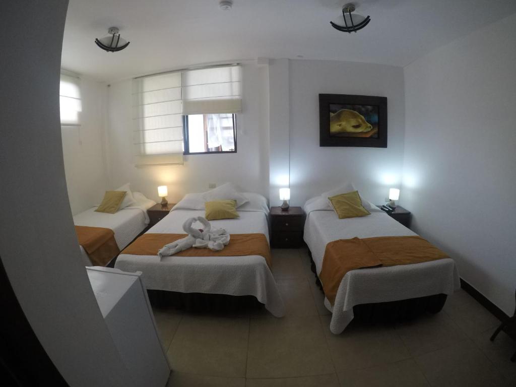 Postel nebo postele na pokoji v ubytování Hostal Costa del Pacifico