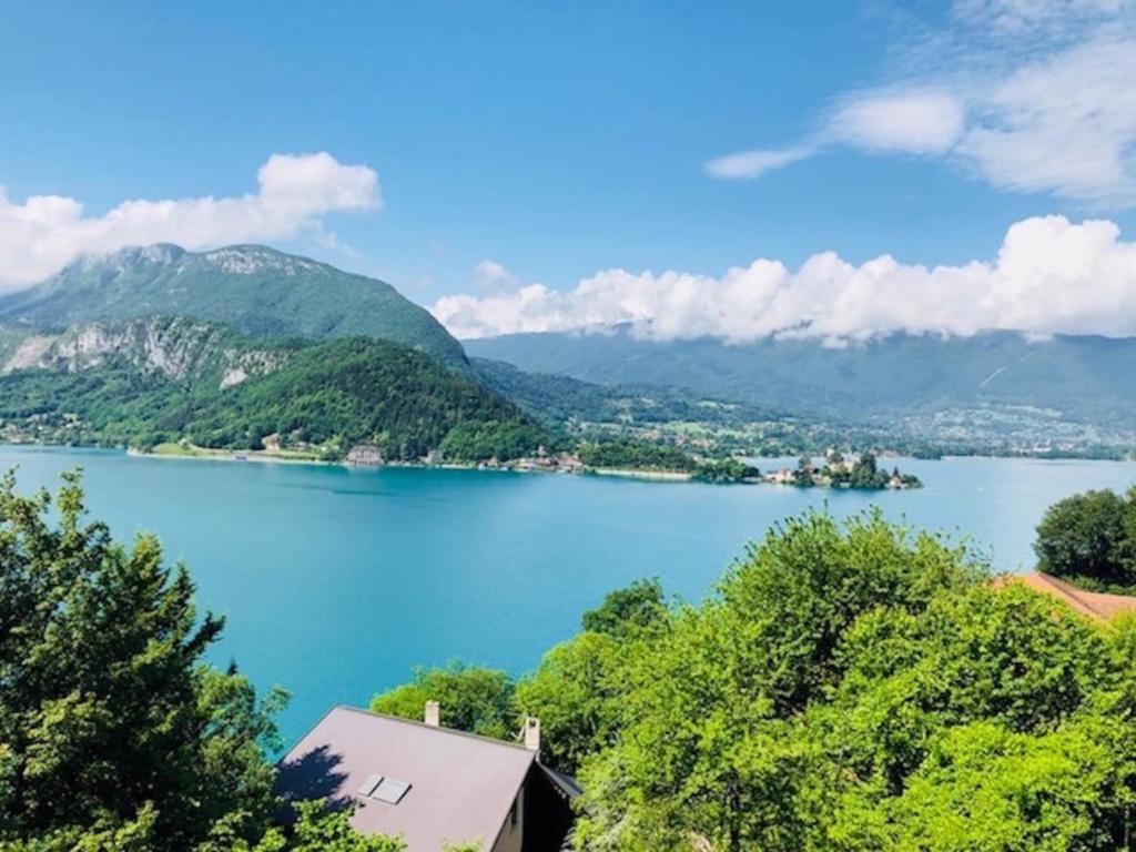a view of a lake with mountains in the background at Angel Services - Le Vivier in Talloires