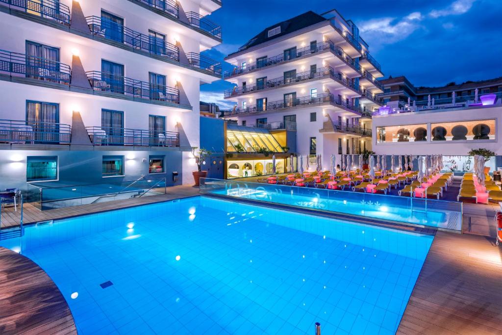een zwembad voor een hotel 's nachts bij Hotel Alhambra in Santa Susanna