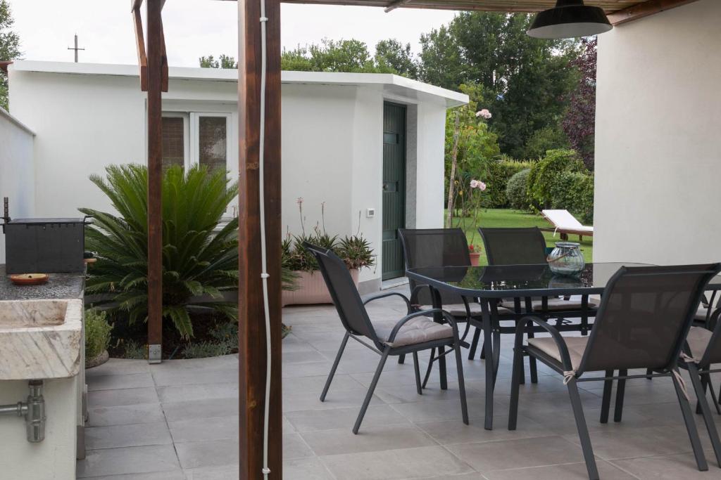 patio z czarnym stołem i krzesłami w obiekcie Macchia home w mieście Marina di Carrara