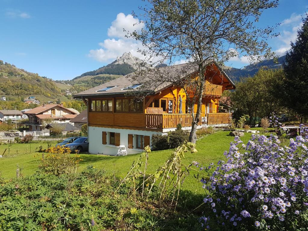 a large house with a balcony on a green yard at Entre Lac Et Montagnes in Bernex