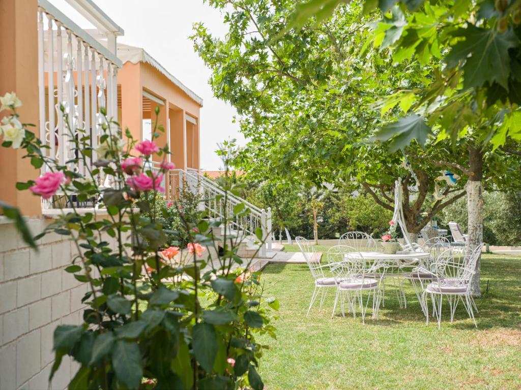 un grupo de sillas y mesas en un patio en Villa Elaia Mare en Fanárion