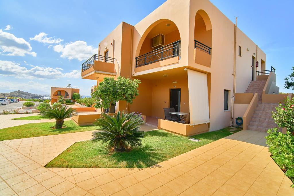 a villa with a view of a building at Nanakis Beach Apartments in Stavros