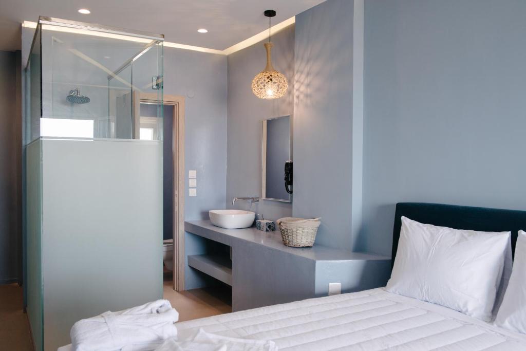 a bathroom with a white bed and a sink at Argilos in Sidari