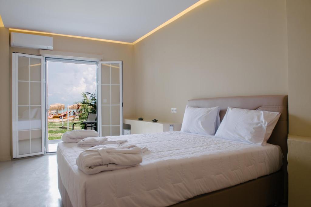 a bedroom with a bed with towels on it at Argilos in Sidari