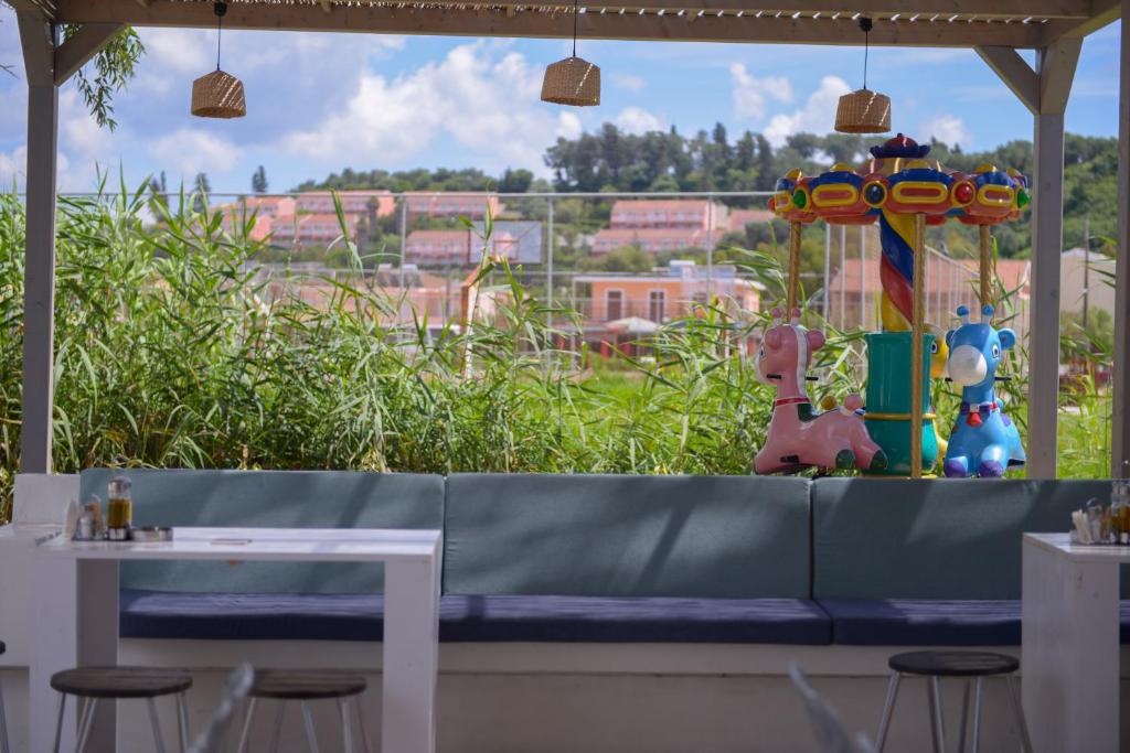 a bench in a restaurant with a view of a city at Argilos in Sidari