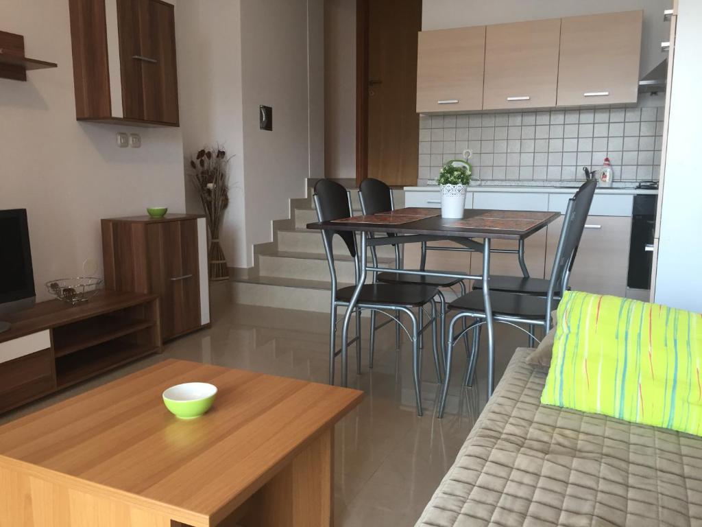 a kitchen and a living room with a table and chairs at Aurora in Pag