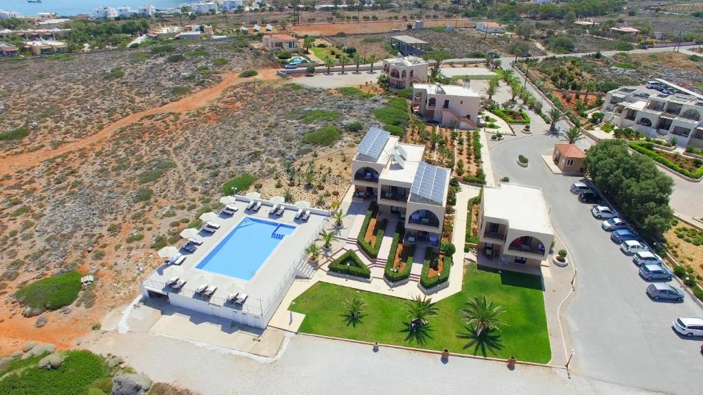 an aerial view of a villa with a swimming pool at Nanakis Beach Apartments in Stavros
