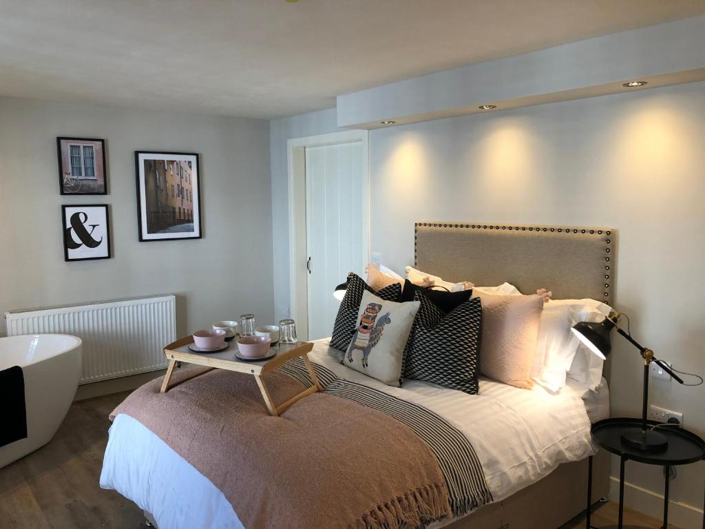 a bedroom with a large bed and a bath tub at number 26 in Conwy