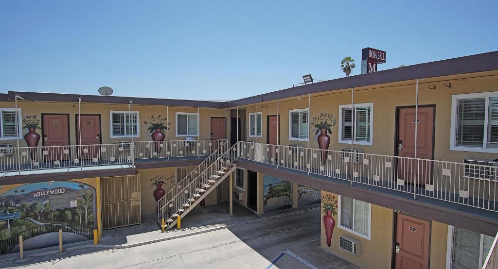 a building with balconies and stairs in front of it at Rosa Bell Motel - Los Angeles in Los Angeles