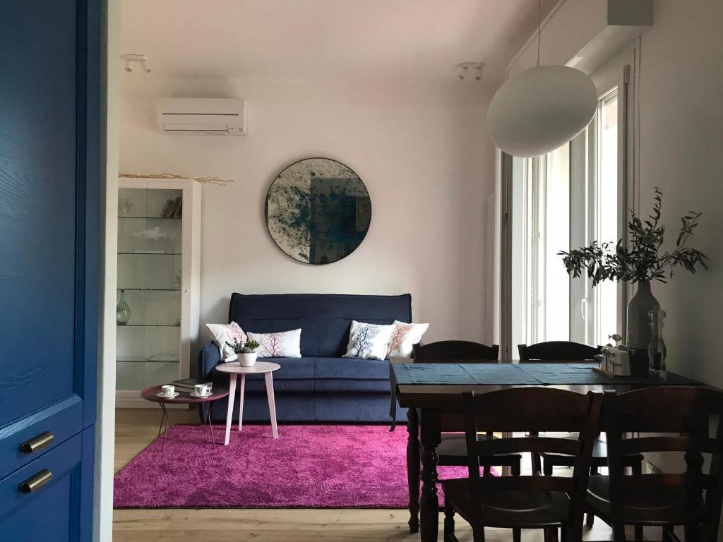 a living room with a blue couch and a table at Fantastic Luxury Apartments in Lerici in Lerici