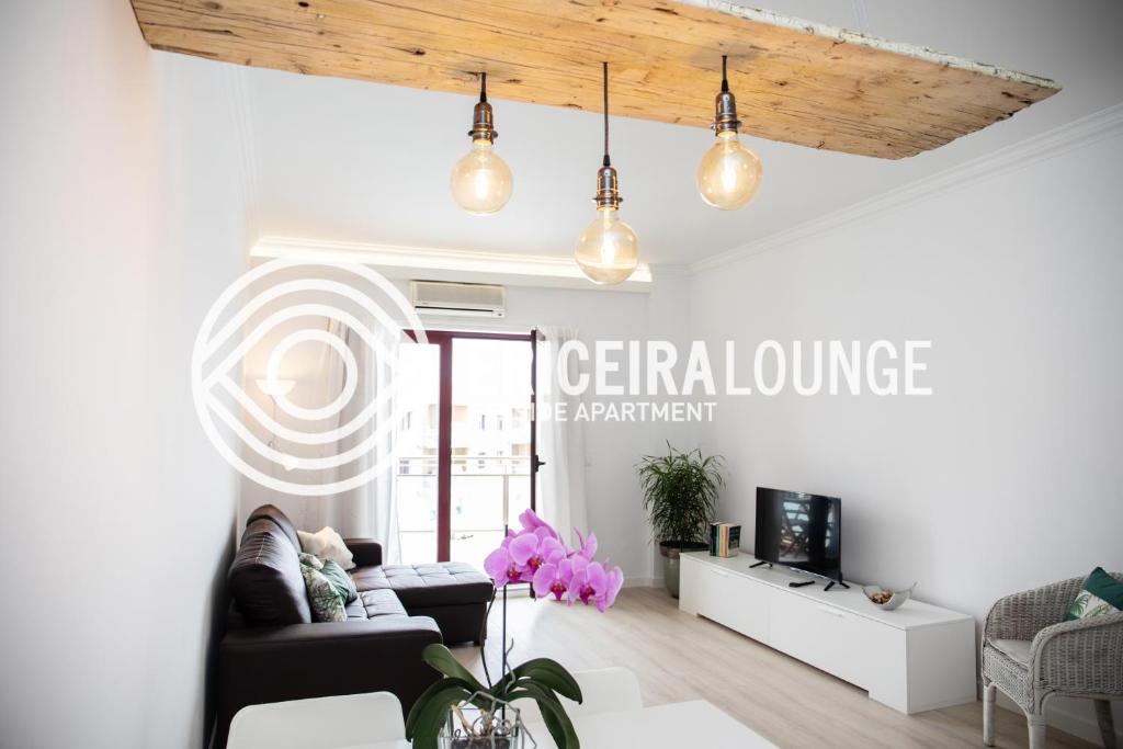 a living room with a couch and a table at Ericeira Lounge Seaside Apartment in Ericeira