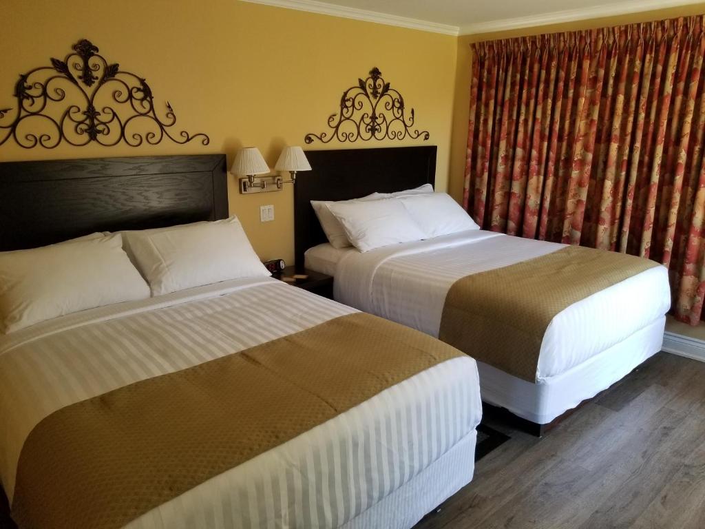 a hotel room with two beds and a window at Sunny Isle Motel in Summerside