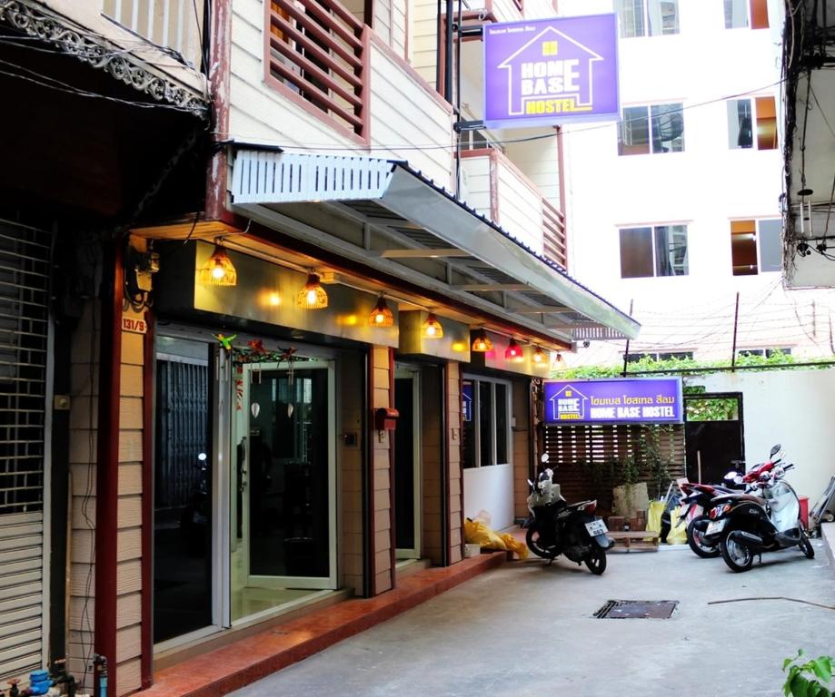 un grupo de motocicletas estacionadas fuera de un edificio en Home Base Hostel en Bangkok