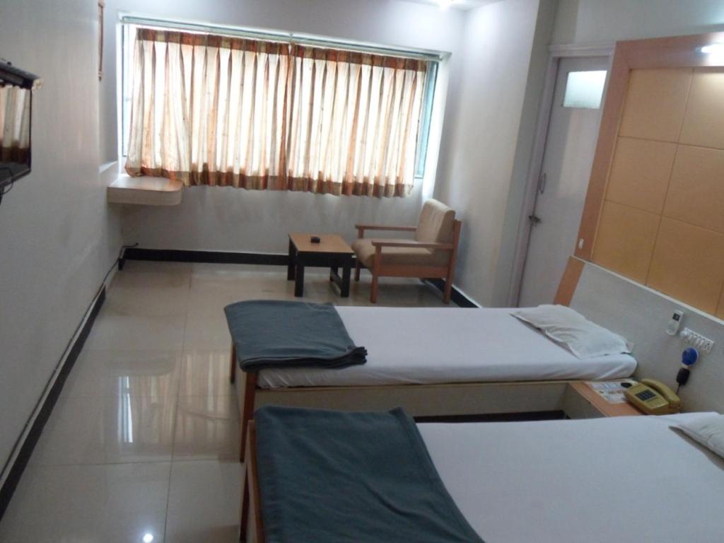 Postel nebo postele na pokoji v ubytování Hotel Vaishali