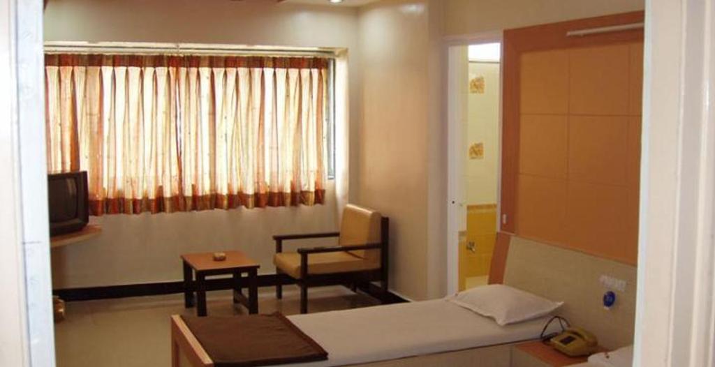 Postel nebo postele na pokoji v ubytování Hotel Vaishali