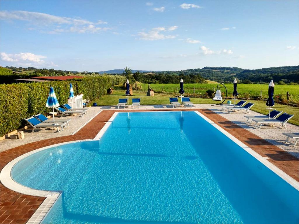 a swimming pool with blue water in a villa at Agriturismo Il Cavallino Saturnia in Semproniano