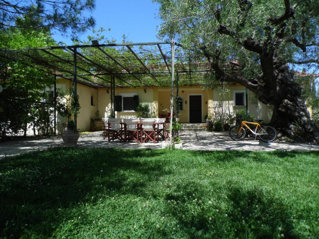 a house with a picnic table in the yard at TheNi Olive Grove Villa in Káto Yerakaríon