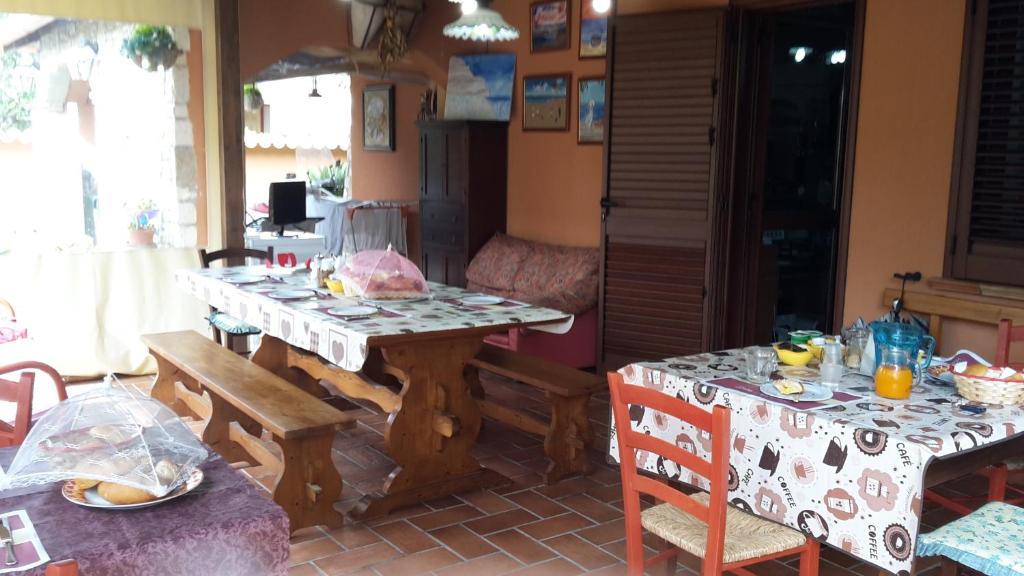 a kitchen with two tables and a table and chairs at Villa Salvatore in San Leone