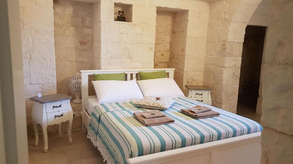 Postel nebo postele na pokoji v ubytování Trulli Petra Chiara