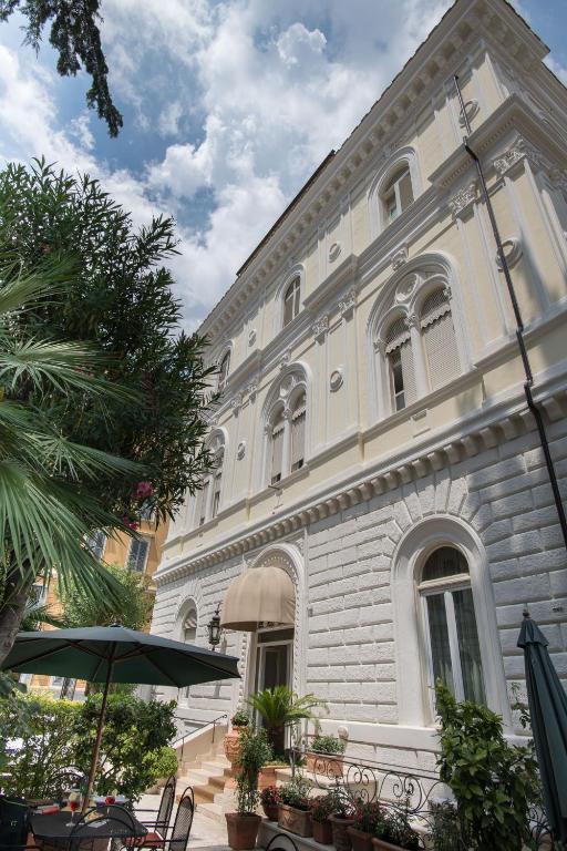 a large white building with a table in front of it at Hotel Villa Delle Rose in Rome