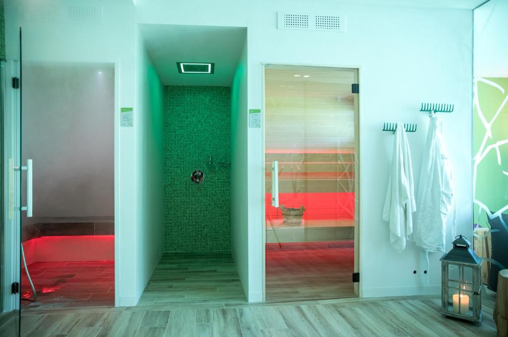 Łazienka z przeszklonymi drzwiami prowadzącymi do prysznica w obiekcie Energy Hotel w mieście Calceranica al Lago