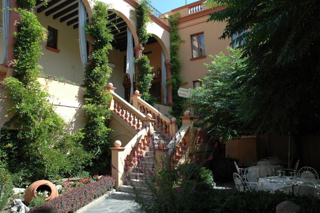 a house with stairs and ivy on it at Hotel Andria in La Seu d'Urgell