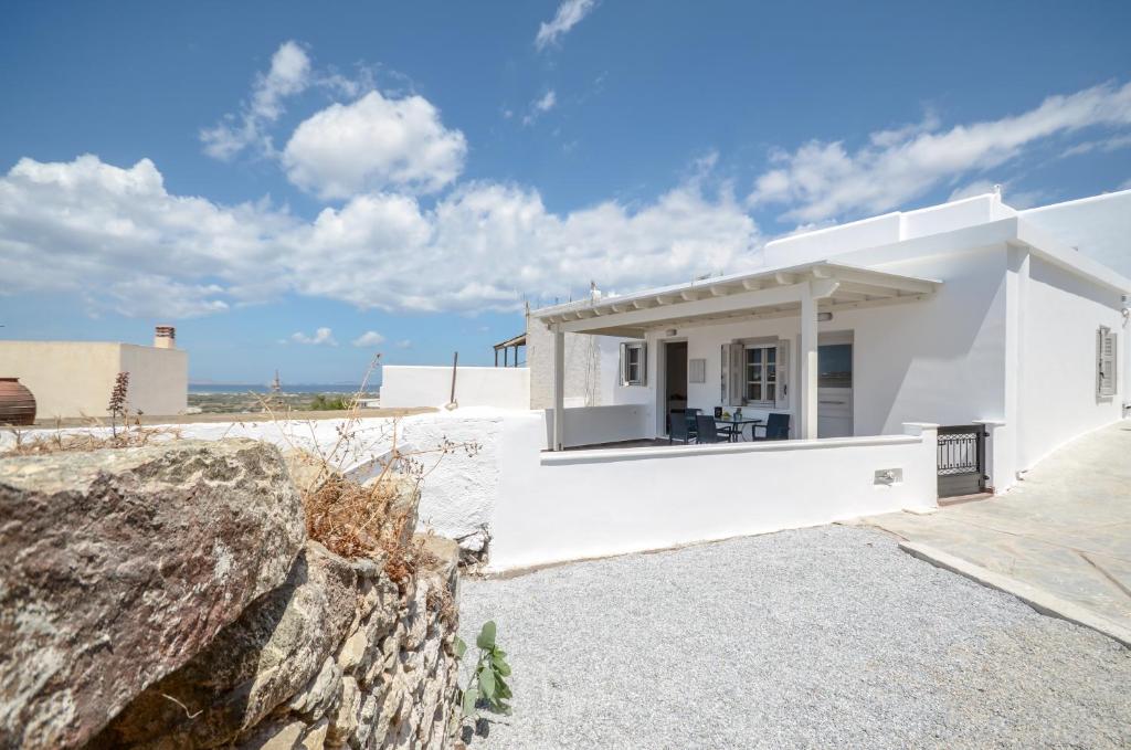 a white house with a view of the ocean at My Family Home in Glinado Naxos