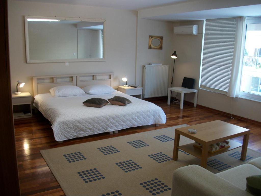 a bedroom with a bed and a living room at Studio Elli in Zakynthos Town