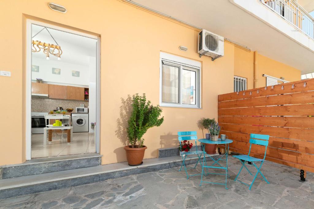 a patio with two chairs and a table in front of a house at Maximos Sea & The City in Rhodes Town