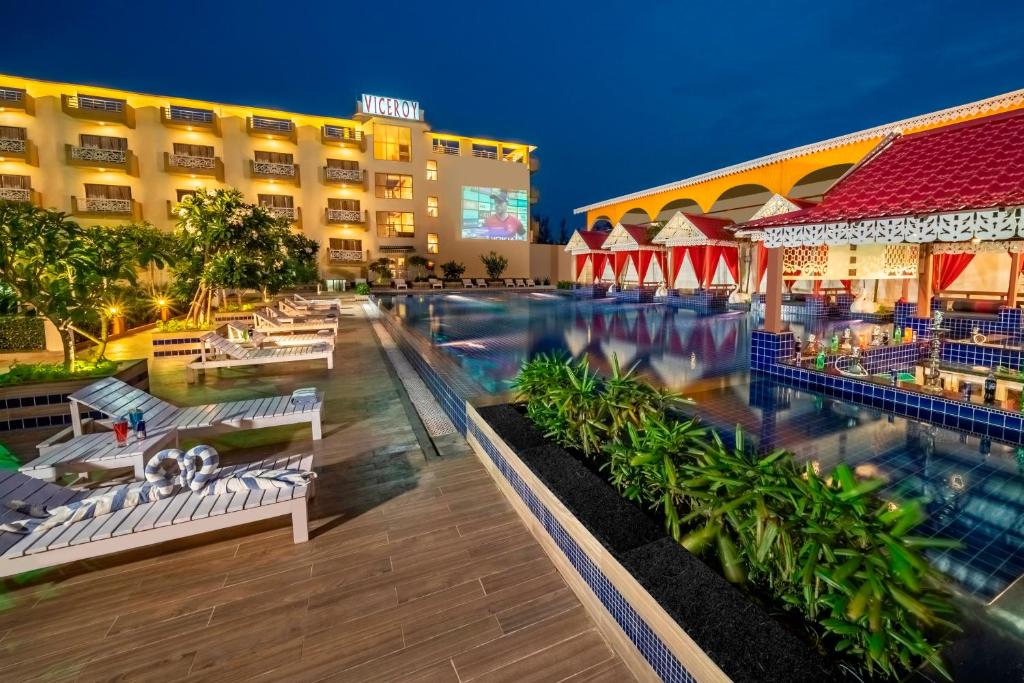 a view of a resort pool at night at Viceroy Beach And Spa Resort in Mandarmoni